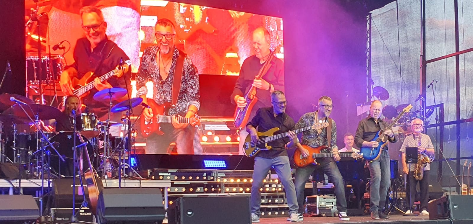 a group of men playing instruments on a stage